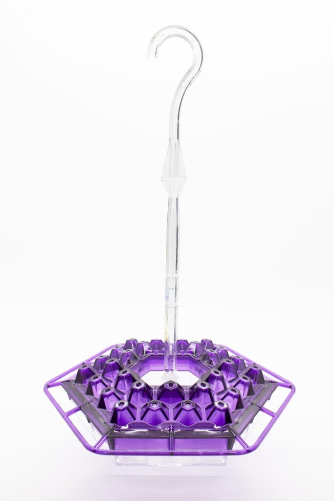 A purple umbrella with a white handle and a purple base.