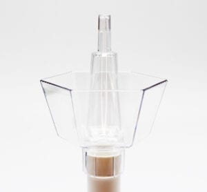 A clear plastic bottle with a brown liquid inside.